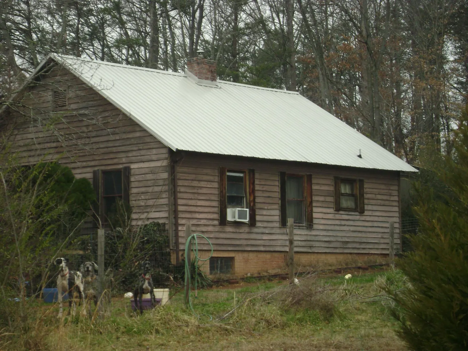 White metal roof on an old wood sided farmhouse, from a Metal Roof Installation job in Wakefield